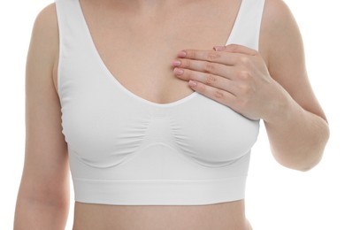 Mammology. Young woman doing breast self-examination on white background, closeup