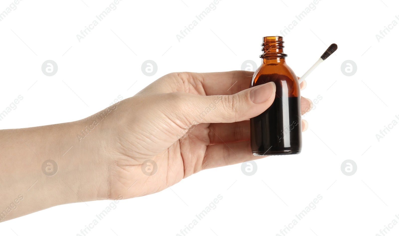 Photo of Woman holding bottle of medical iodine and cotton bud on white background, closeup