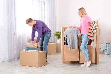 Photo of Young couple near wardrobe boxes at home