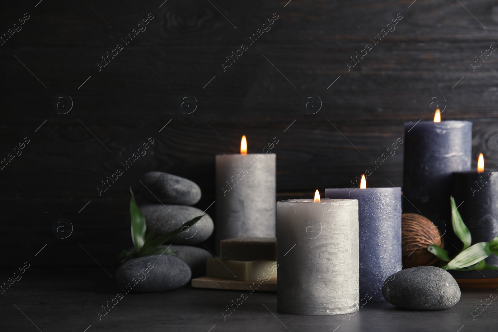 Photo of Spa composition with burning candles on table, space for text