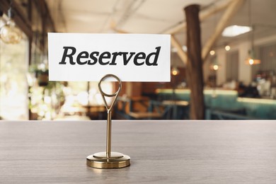 Sign Reserved on wooden table in restaurant