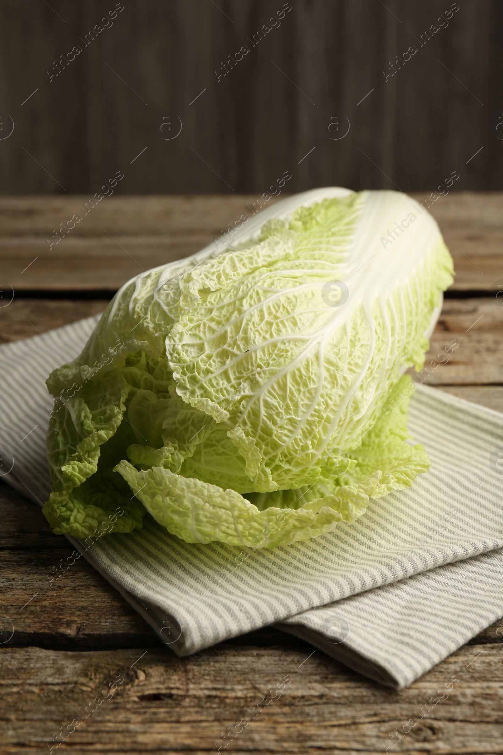 Photo of Fresh ripe Chinese cabbage on wooden table