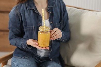 Photo of Woman with delicious smoothie indoors, closeup view
