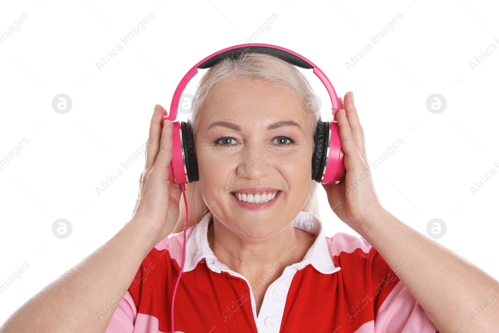 Photo of Mature woman enjoying music in headphones isolated on white