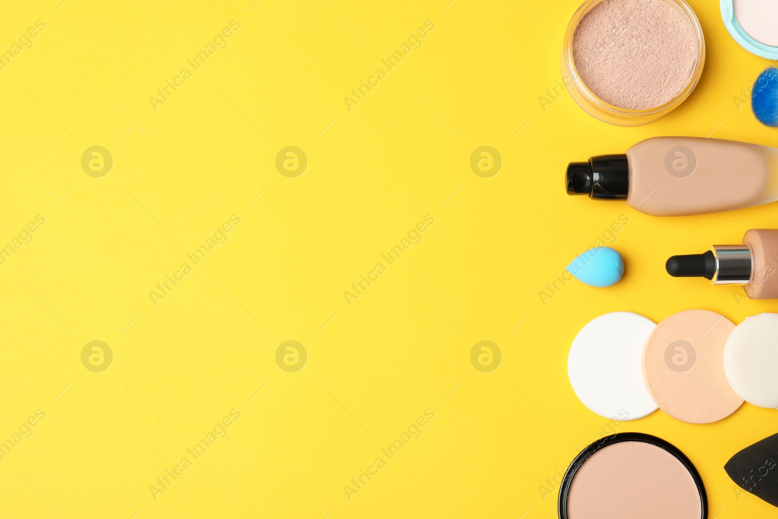 Photo of Flat lay composition with skin foundation, powder and beauty accessories on color background. Space for text