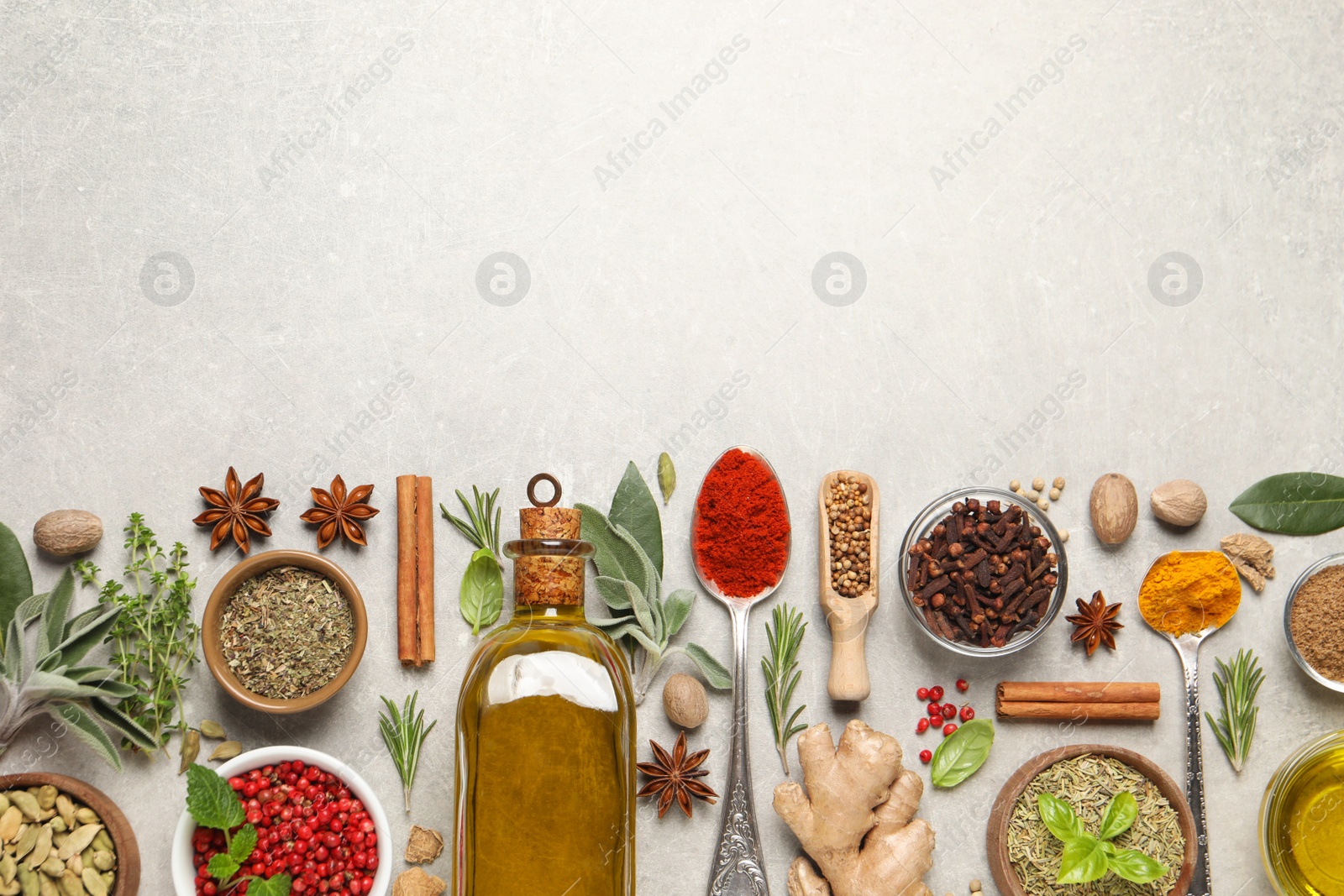 Photo of Different herbs and spices on grey table, flat lay. Space for text