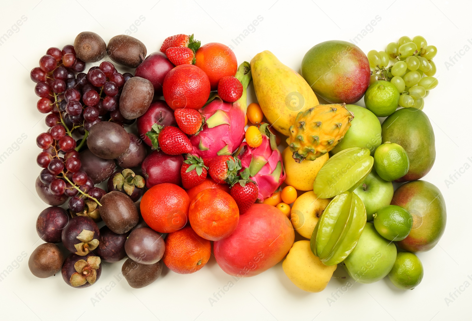 Photo of Assortment of fresh exotic fruits on white background, flat lay