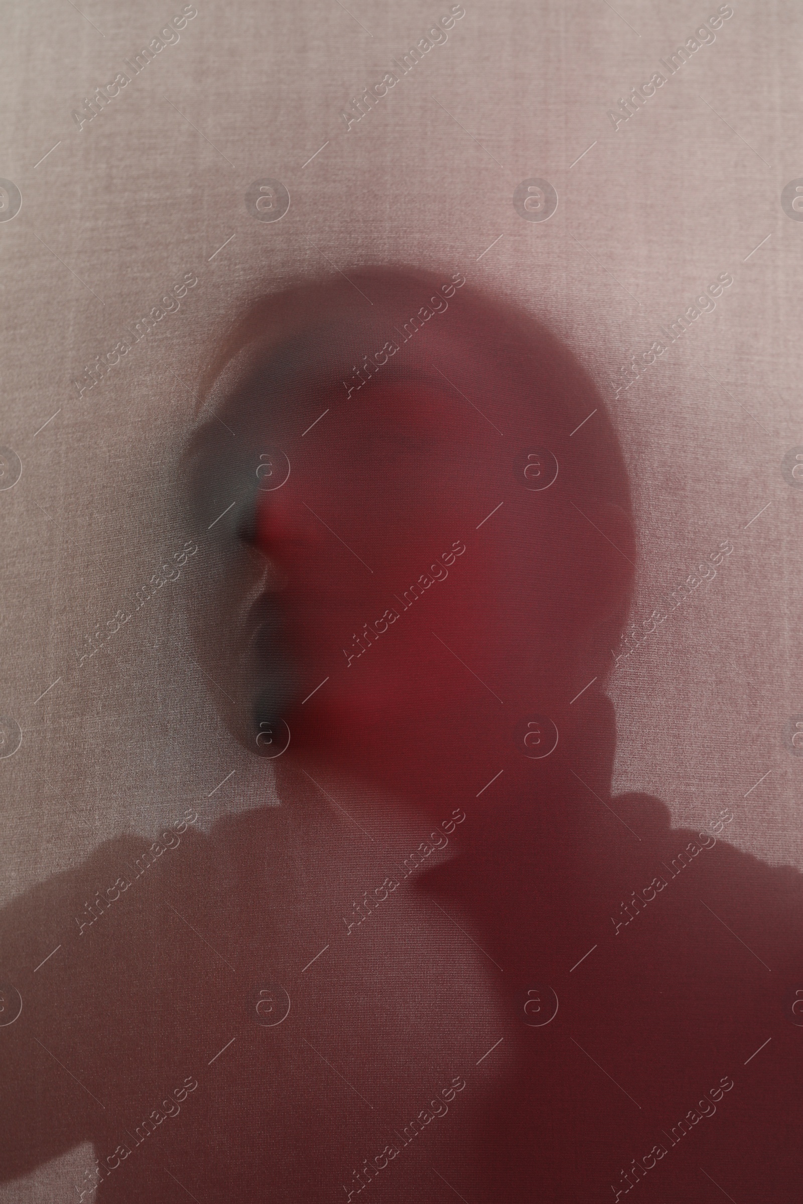 Photo of Silhouette of creepy ghost behind cloth, color toned