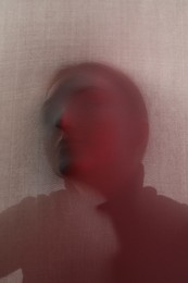 Photo of Silhouette of creepy ghost behind cloth, color toned