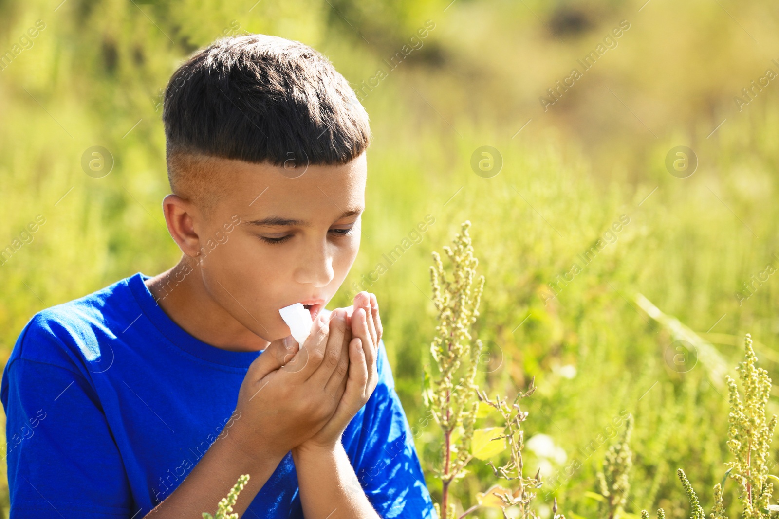 Photo of Little boy suffering from ragweed allergy outdoors