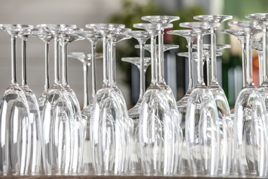 Photo of Empty glasses on wooden table against blurred background