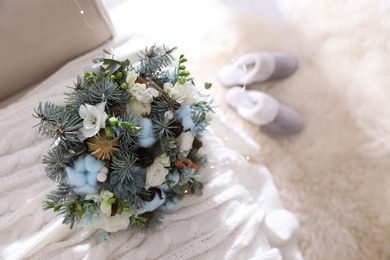 Photo of Beautiful wedding winter bouquet on sofa indoors. Space for text