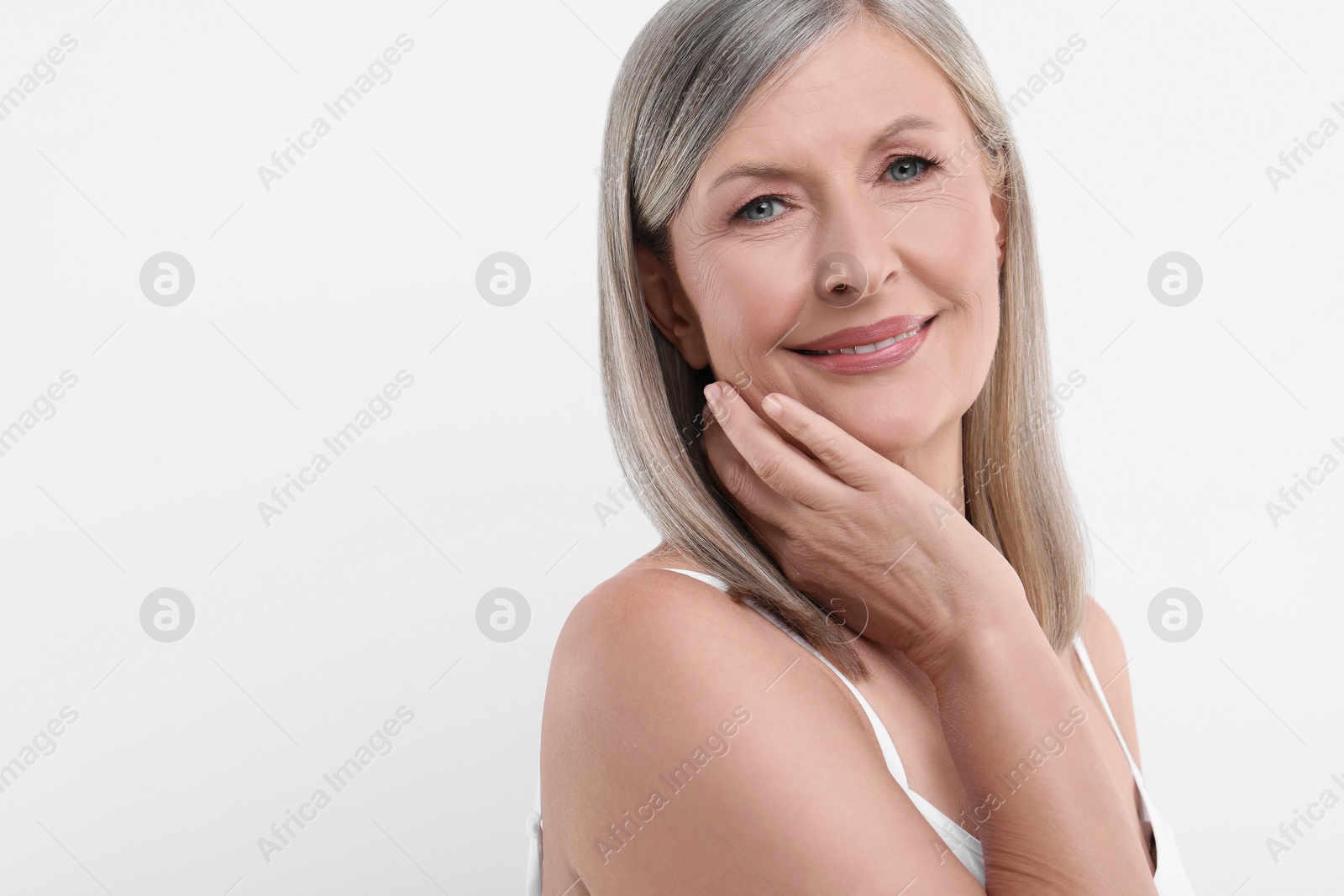 Photo of Portrait of beautiful senior woman on white background. Space for text