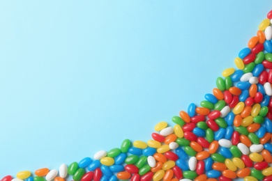 Photo of Flat lay composition with delicious jelly beans on color background. Space for text