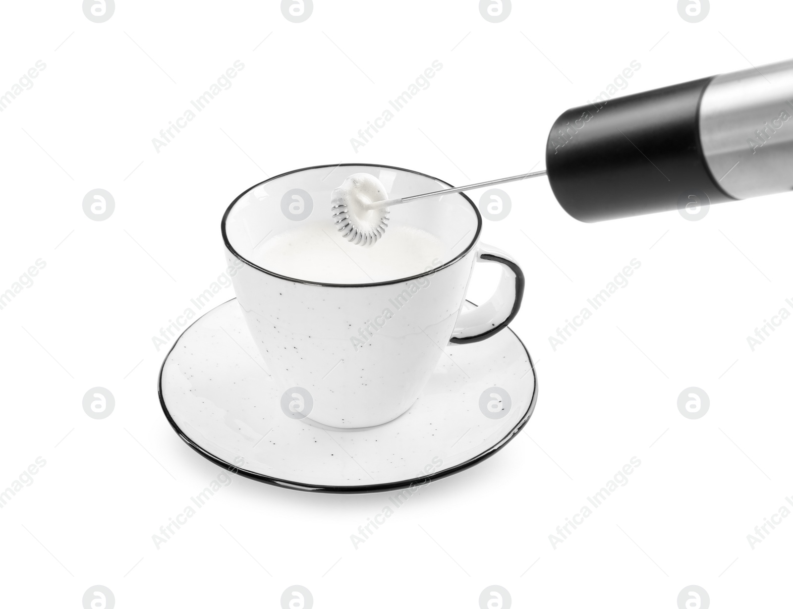 Photo of Whisking milk in cup with mini mixer (frother wand) isolated on white