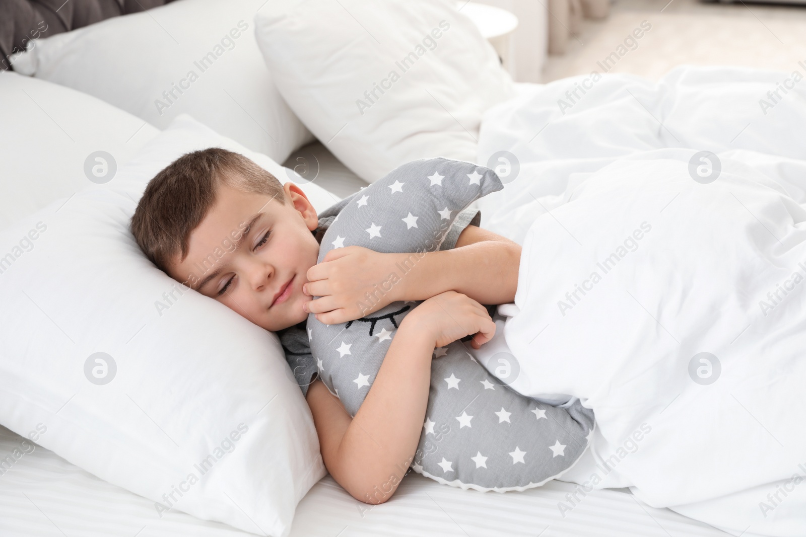 Photo of Cute boy with toy sleeping in bed