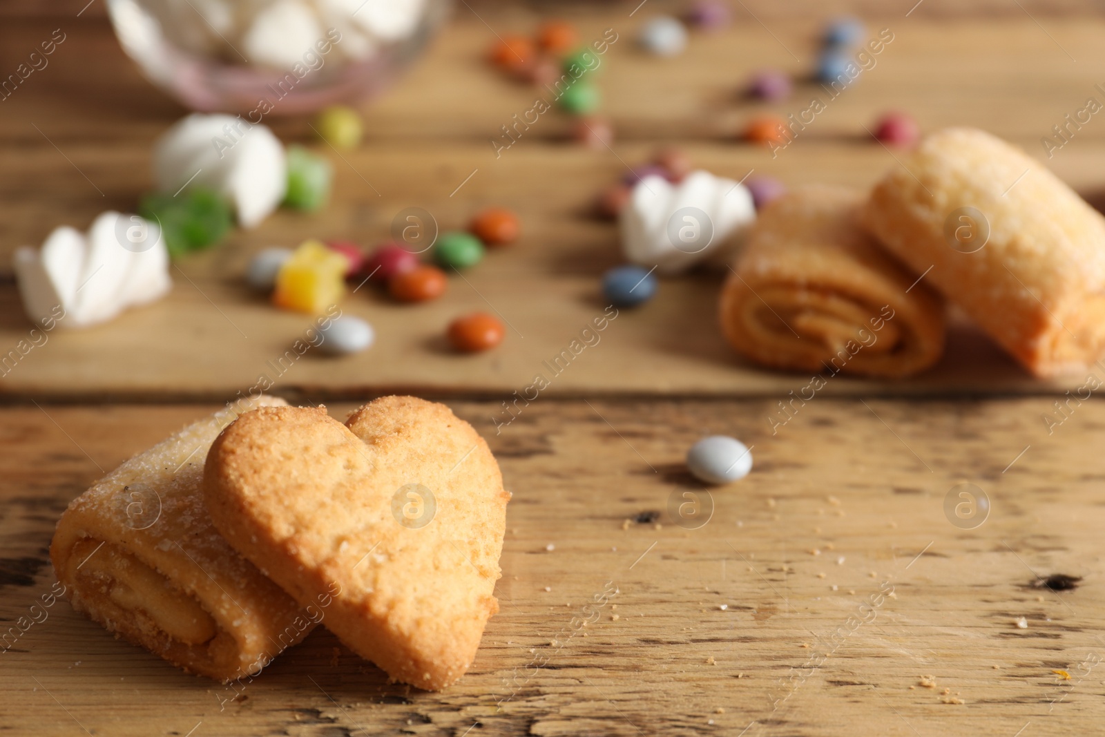 Photo of Delicious cookies on wooden table, closeup. Space for text