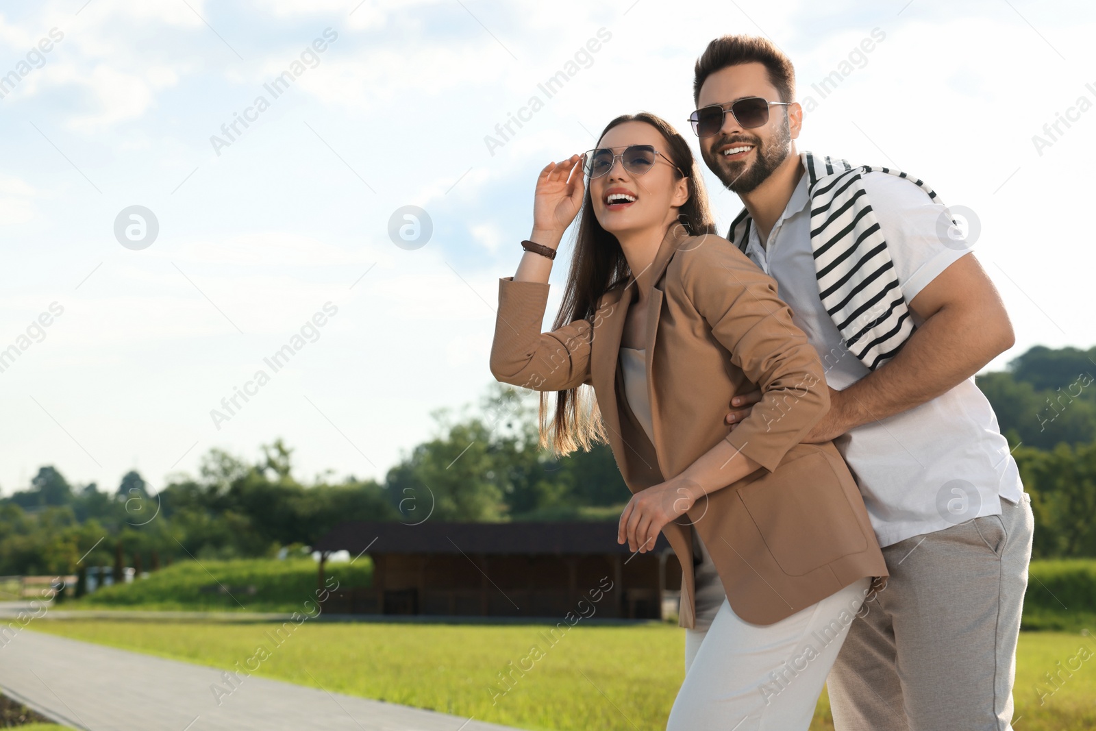 Photo of Romantic date. Beautiful couple spending time together in park, space for text