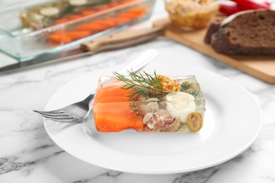 Photo of Delicious aspic with meat and vegetables served on white marble table