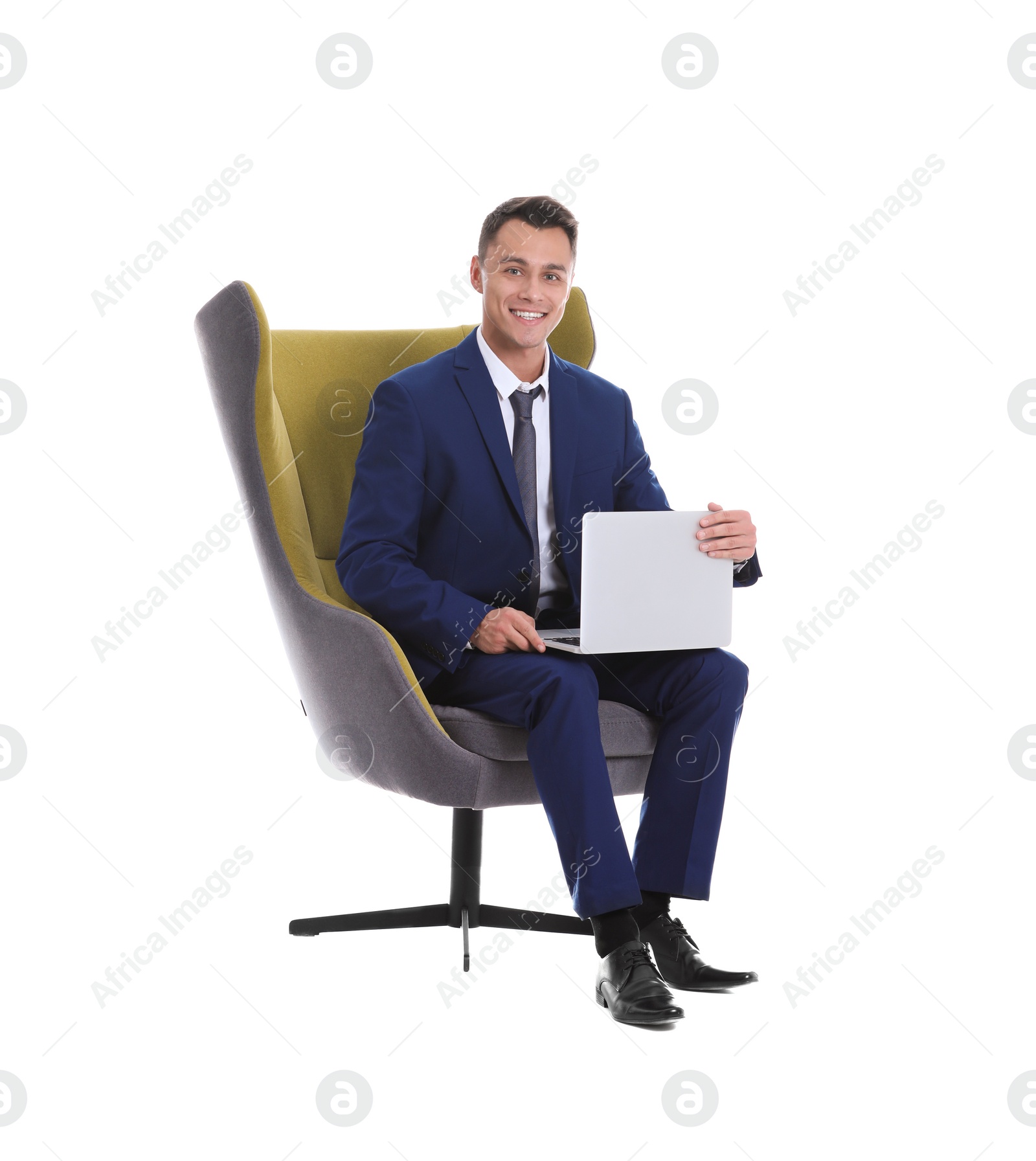 Photo of Young businessman with laptop sitting in comfortable armchair on white background