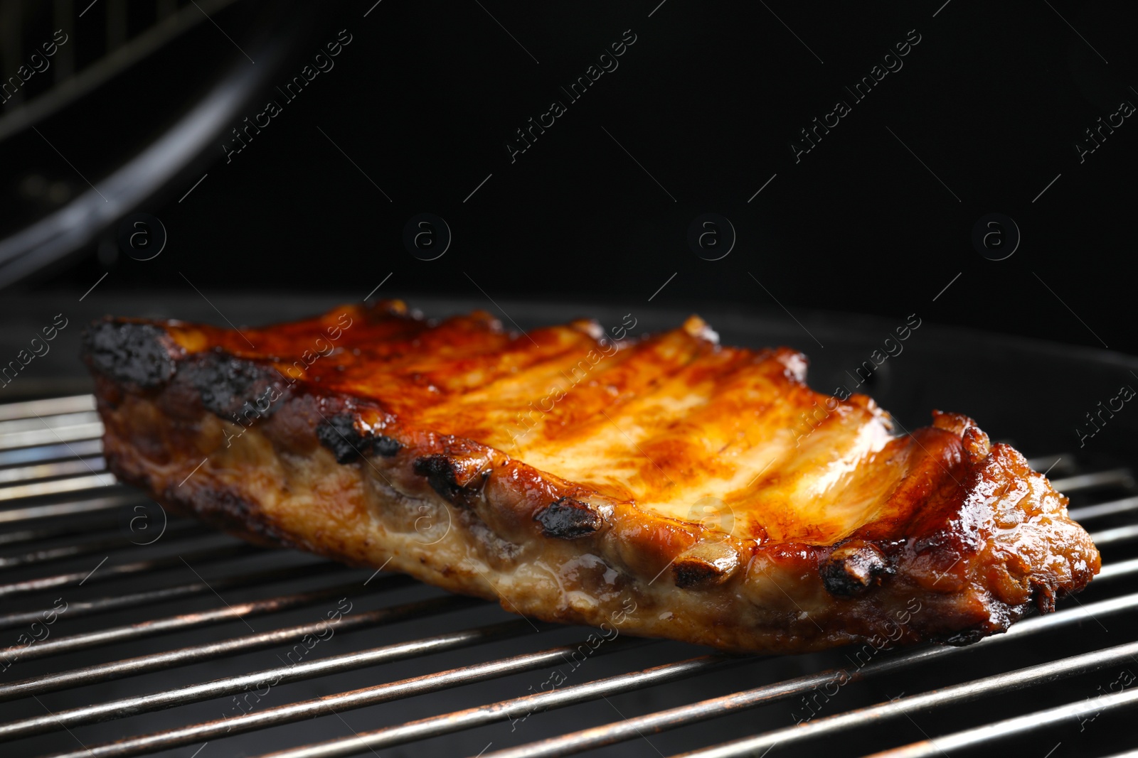 Photo of Delicious ribs on barbecue grill. Yummy meat