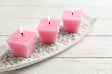 Photo of Composition with three burning candles on white wooden table. Space for text