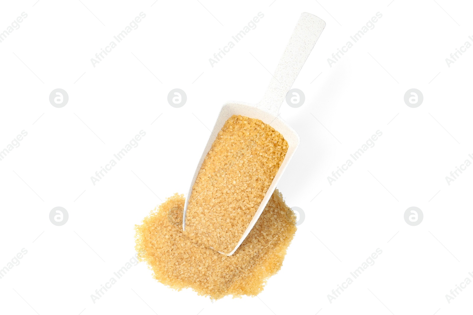 Photo of Pile of brown sugar and scoop isolated on white, top view