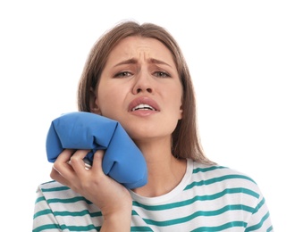 Young woman suffering from toothache on white background