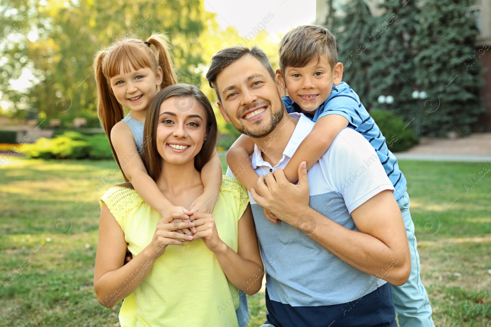 Photo of Happy family with children spending time together in green park on sunny day