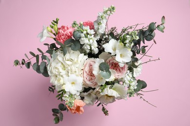 Photo of Bouquet of beautiful flowers on pink background, top view