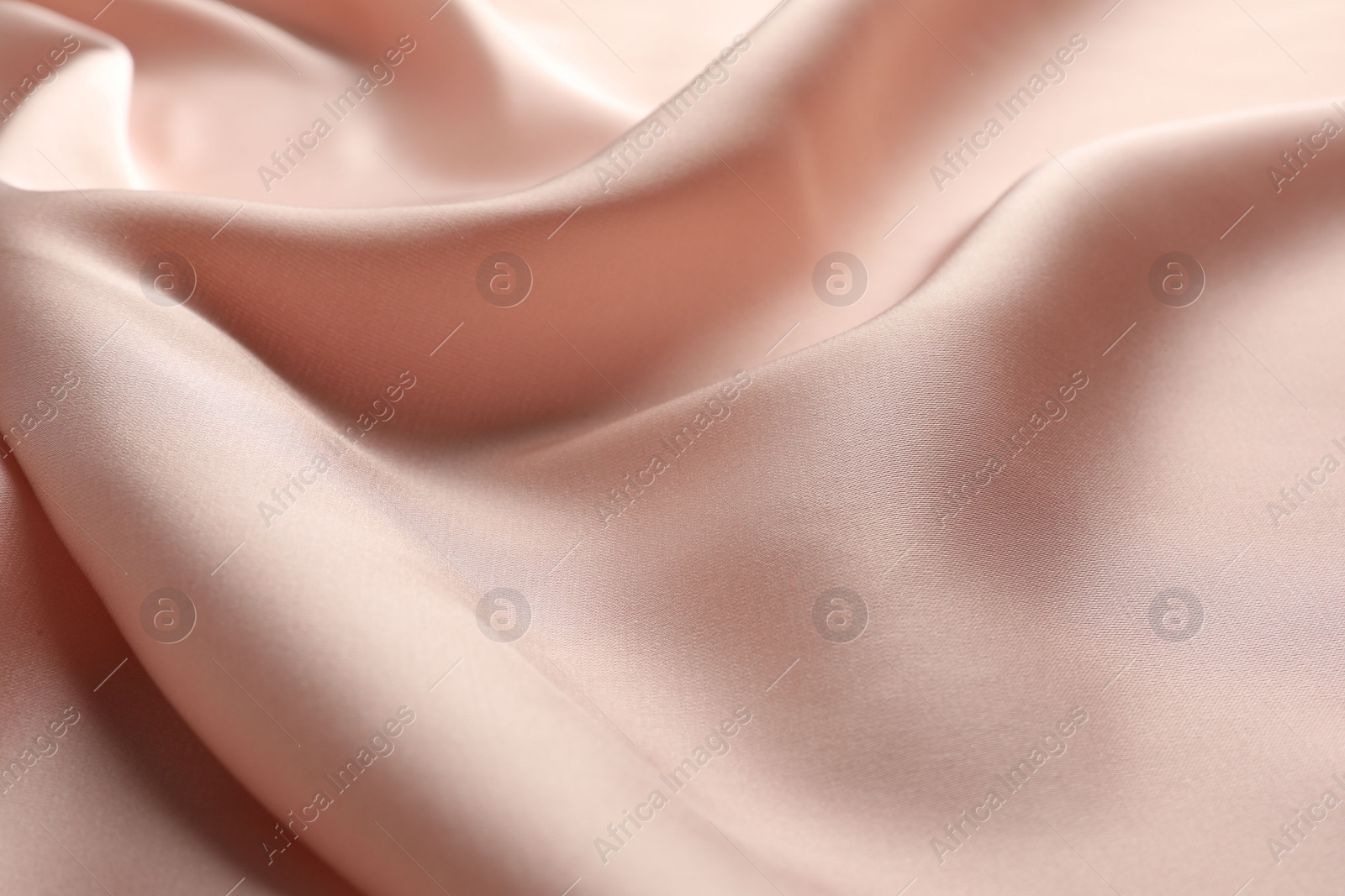 Photo of Crumpled pink silk fabric as background, closeup