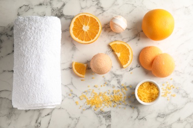 Flat lay composition with bath bombs, towel and oranges on marble background