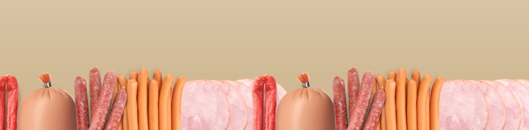 Many different tasty sausages on light brown background, flat lay. Banner design