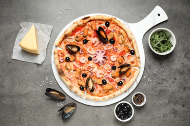 Photo of Delicious seafood pizza on grey table, flat lay