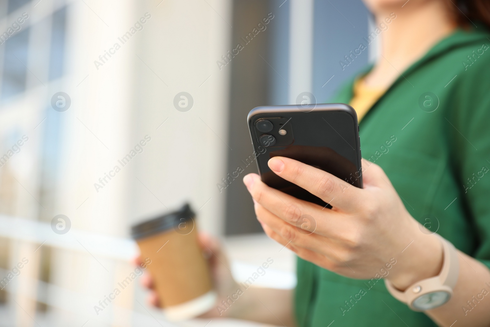 Photo of MYKOLAIV, UKRAINE - MARCH 16, 2020: Woman holding iPhone 11 Black outdoors, closeup