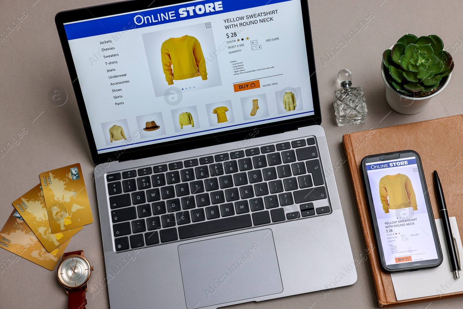 Photo of Online shopping. Composition with laptop on grey background, above view