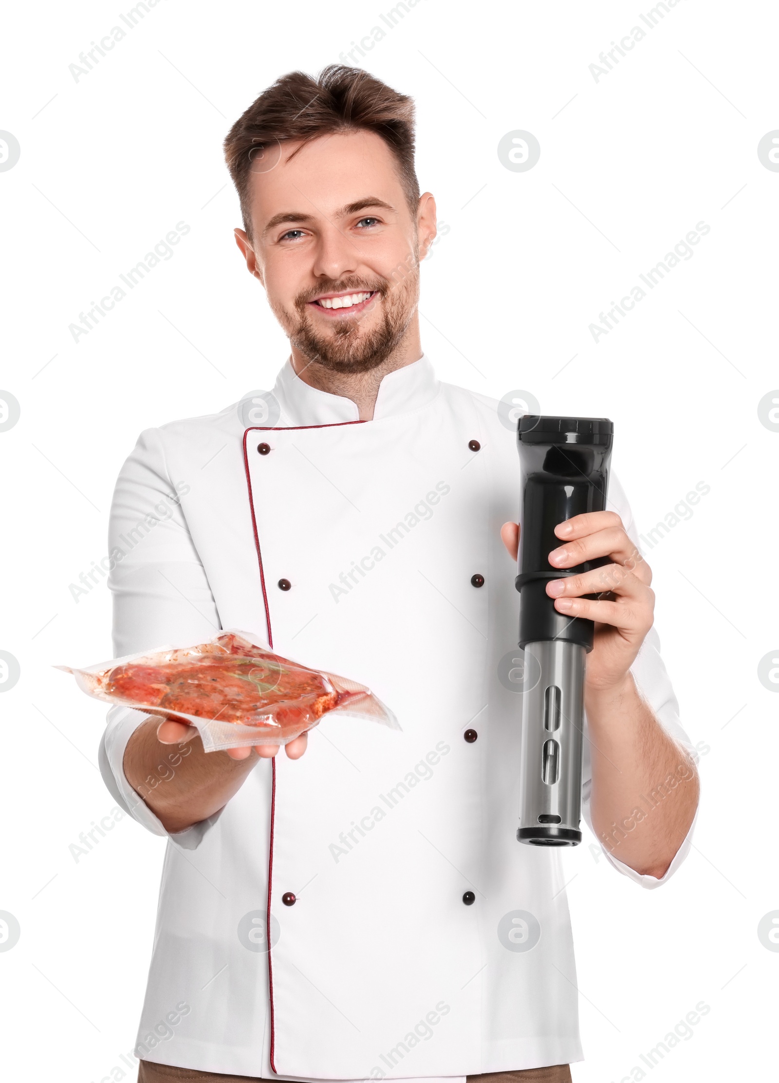 Photo of Smiling chef holding sous vide cooker and meat in vacuum pack on white background