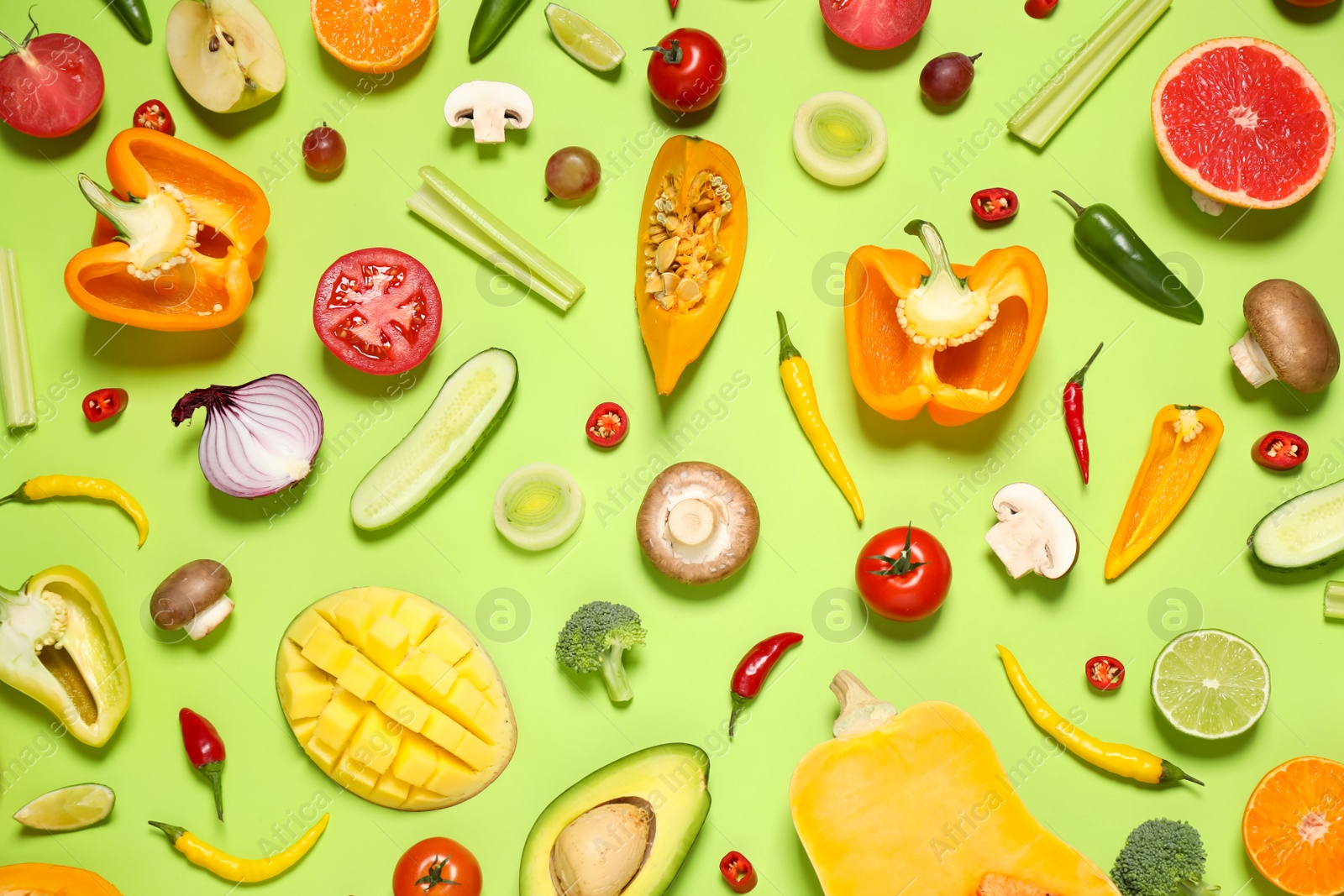 Photo of Flat lay composition with fresh organic fruits and vegetables on light green background