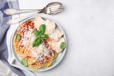 Photo of Delicious pasta with tomato sauce, chicken and parmesan cheese on white table, flat lay. Space for text