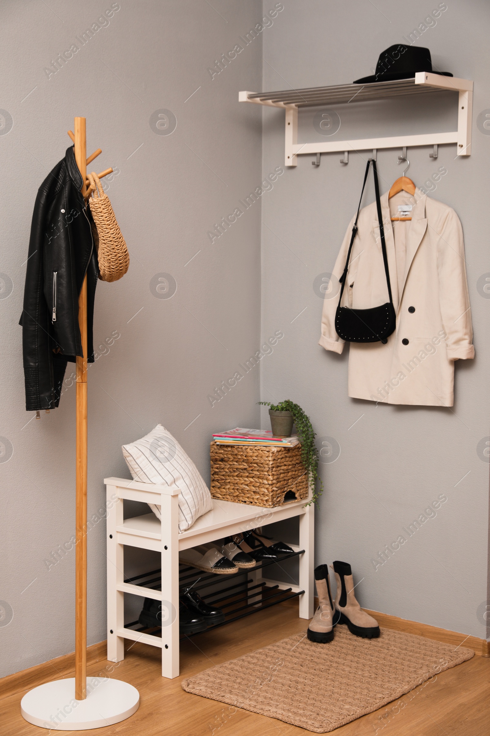 Photo of Modern hallway interior with shoe rack and wooden coat stand