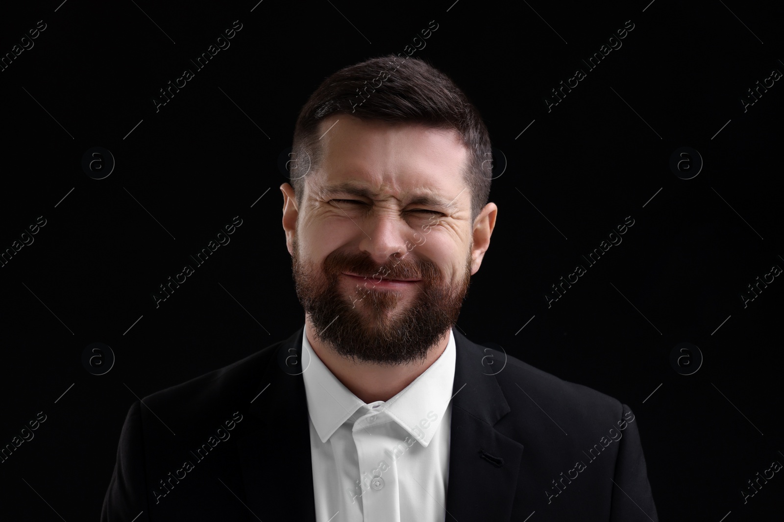Photo of Personality concept. Emotional man on black background
