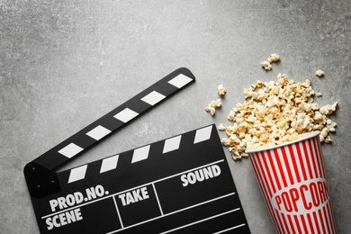 Clapperboard and popcorn on table