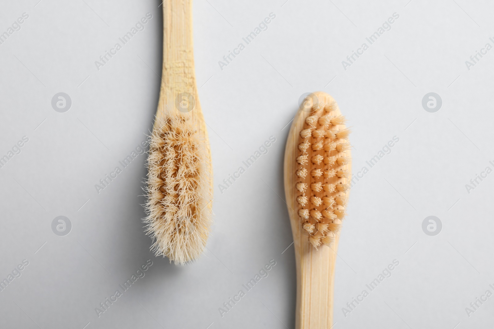 Photo of Old and new bamboo toothbrushes on white background, flat lay