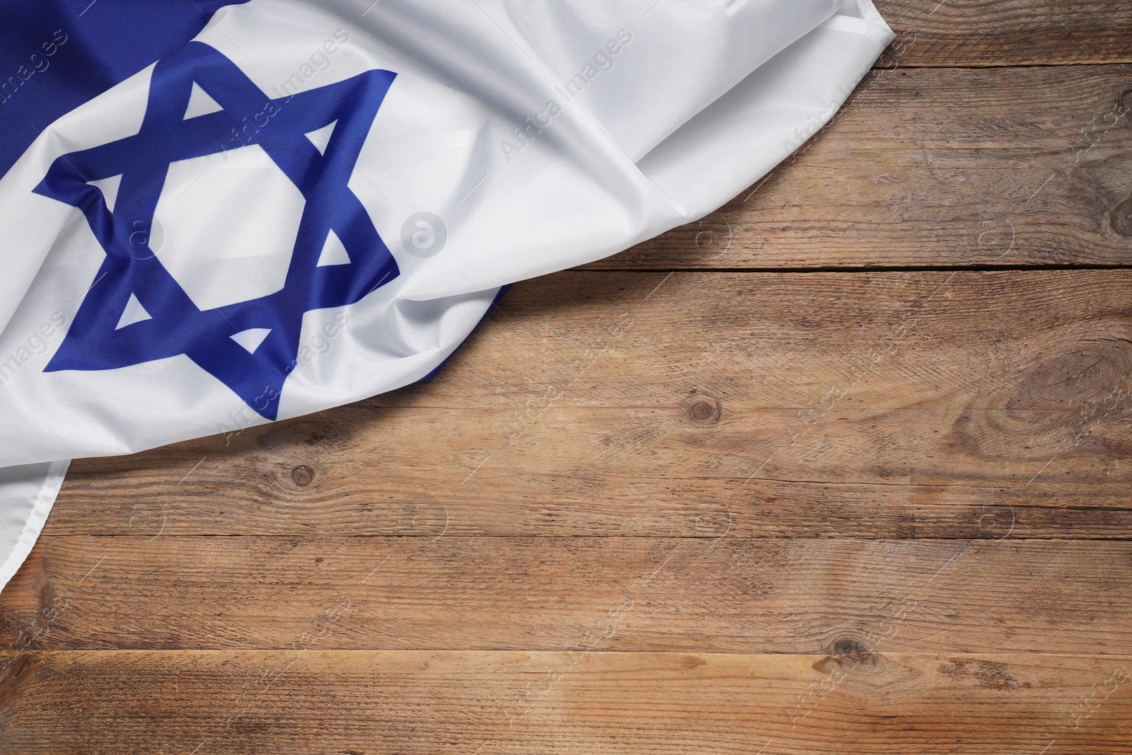 Photo of Flag of Israel on wooden background, top view and space for text. National symbol