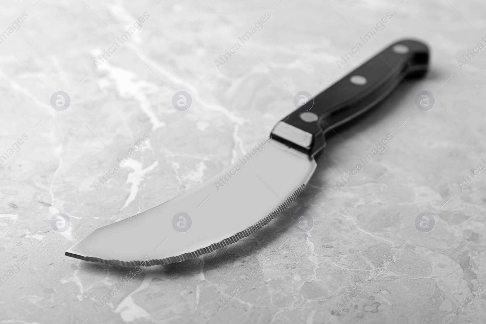 Photo of Sharp pizza knife with plastic handle on grey background