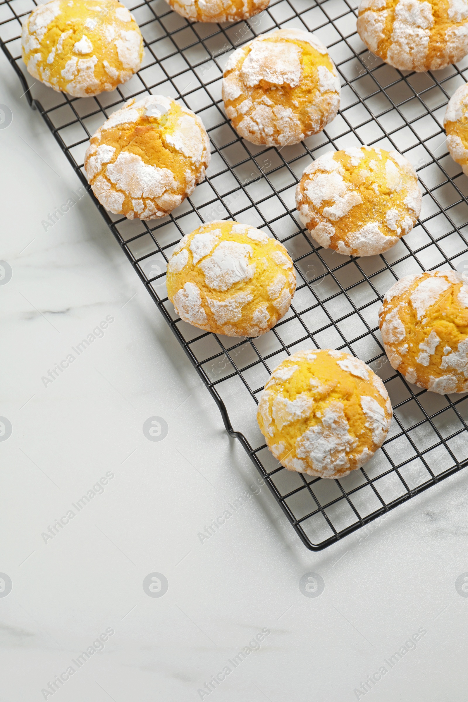 Photo of Tasty homemade lemon cookies on white marble table, above view