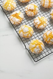 Photo of Tasty homemade lemon cookies on white marble table, above view