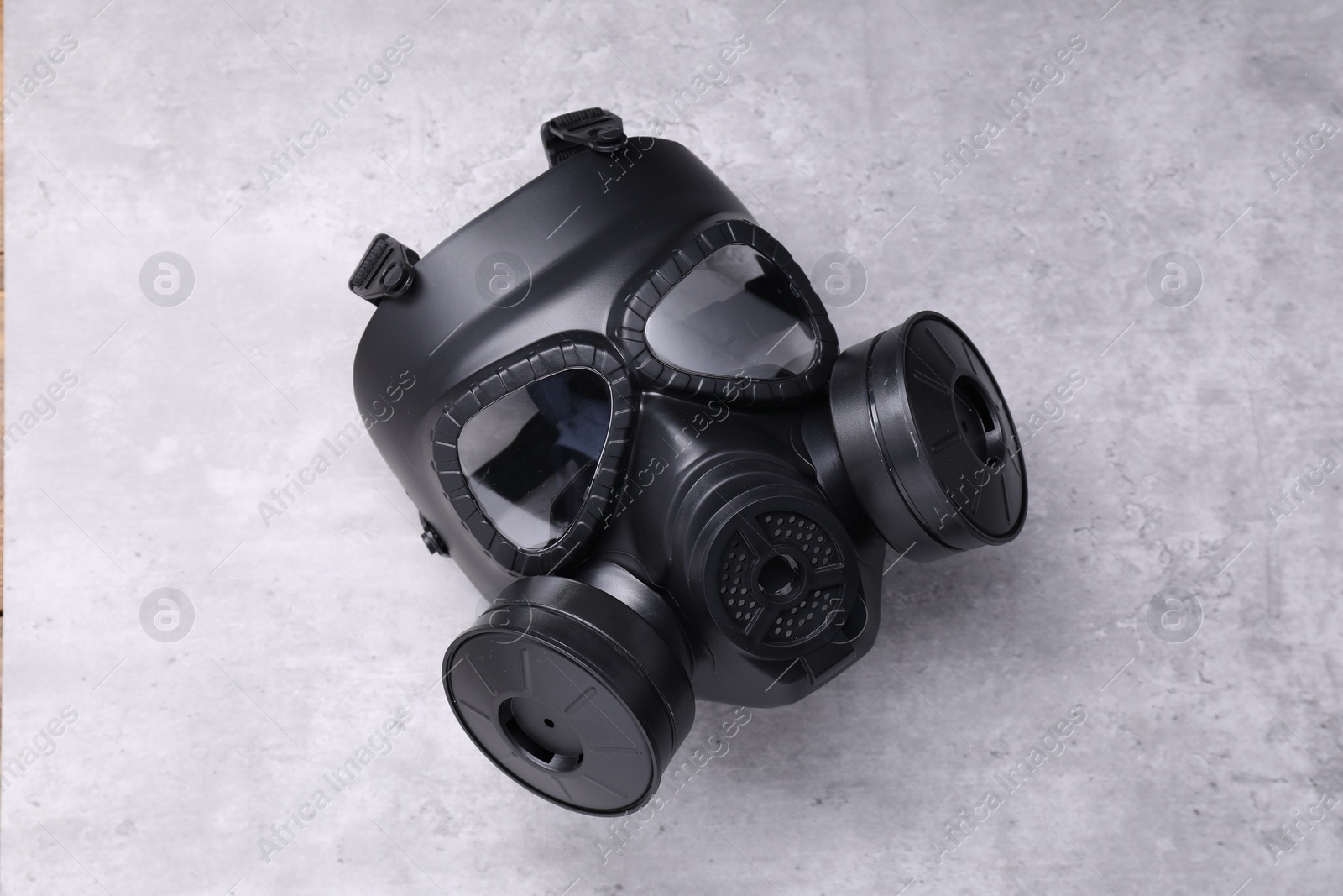 Photo of One gas mask on grey textured background, top view