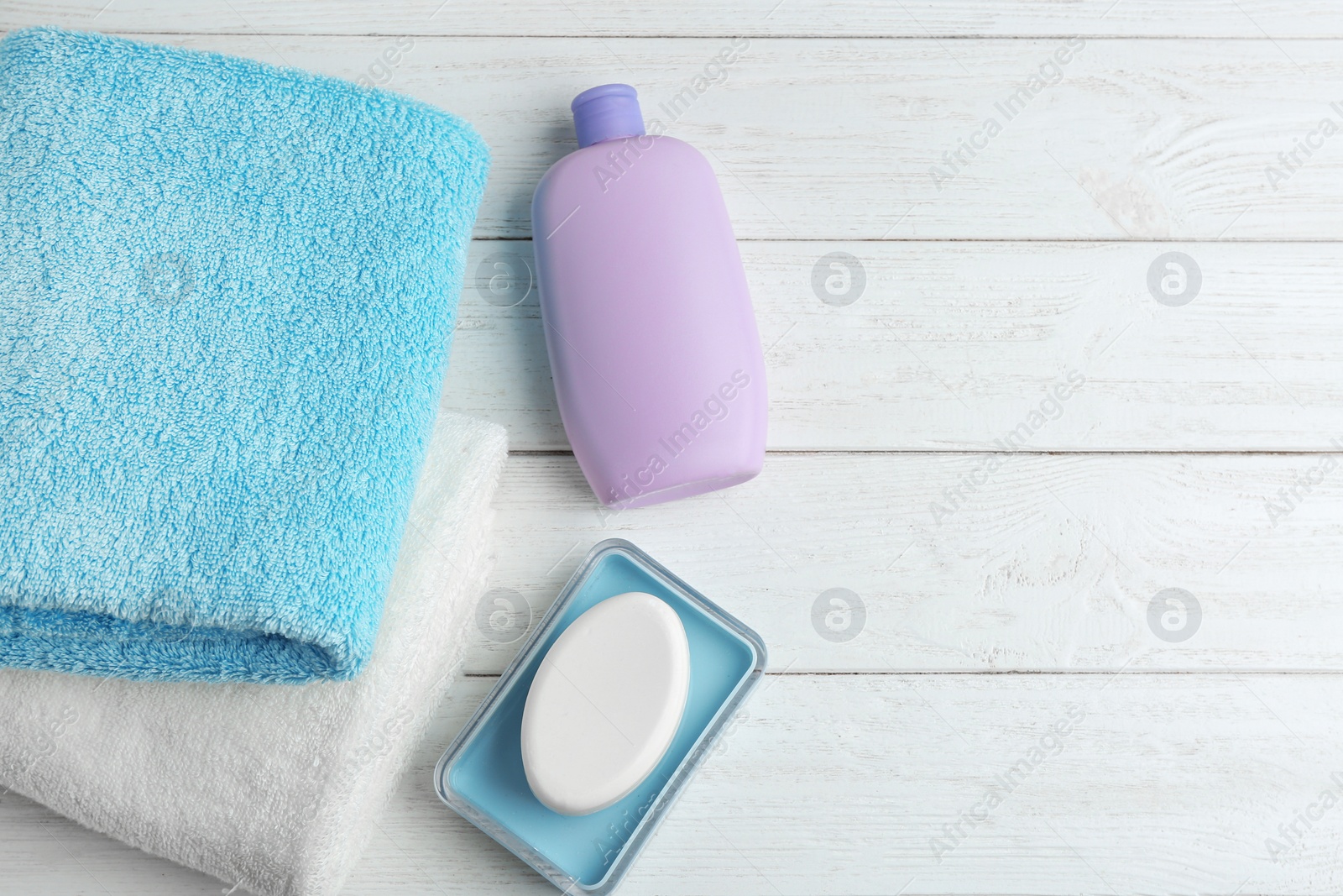 Photo of Flat lay composition with fresh towels on white wooden table. Space for text