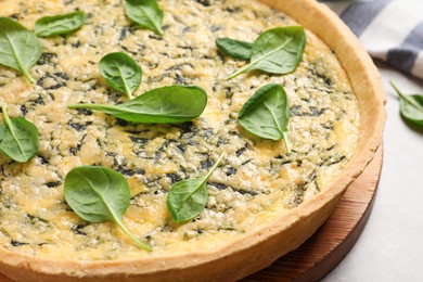 Delicious homemade spinach pie on light grey table, closeup